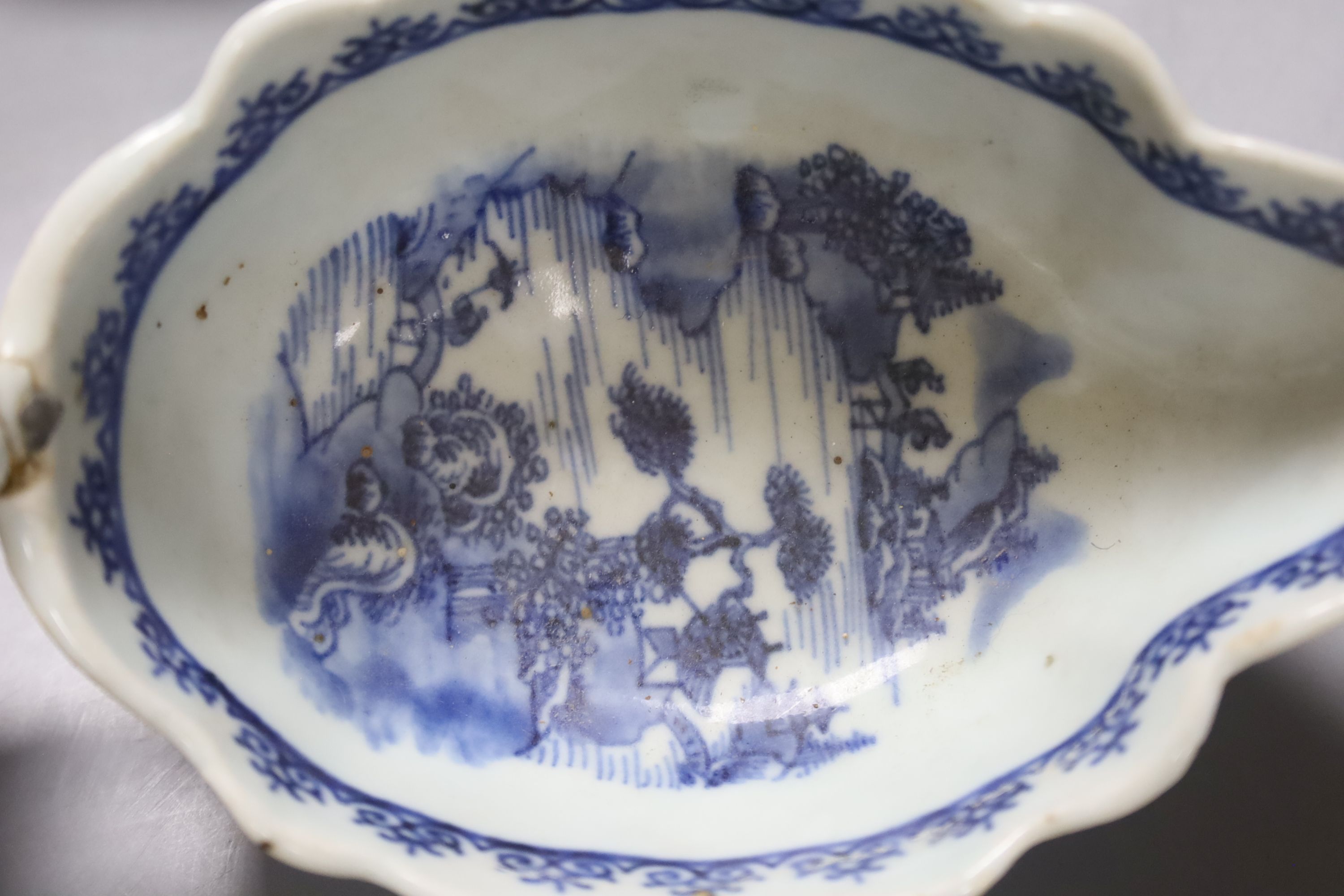 A Worcester Doughnut pattern blue and white sauceboat circa 1775 and two Chinese blue and white sauceboats, Qianlong period, longest 21cm